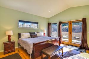 a bedroom with a bed and a large window at Colorado Mountain Getaway about 12 Mi to Buena Vista! in Nathrop