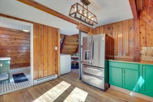 a kitchen with a refrigerator and wooden walls at Pocono Getaway A frame Cabin w/ Hot Tub Sauna in East Stroudsburg