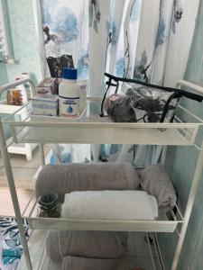 a shelf with towels and other items in a bathroom at Neartheairport in Fiumicino