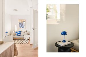 a room with white walls and a living room with a table at Charming Peacful studio in Bergen