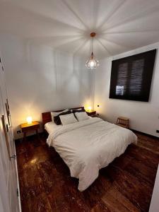 a bedroom with a large bed and two tables at Casa de campo con piscina in Las Palmas de Gran Canaria