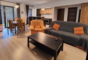 een woonkamer met een bank en een tafel bij Mega Residence in Târgovişte