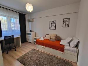 a bedroom with a bed and a desk and a computer at Mega Residence in Târgovişte
