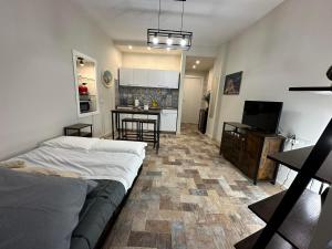 a bedroom with a bed and a kitchen with a table at La dimora di Pino in Ripa