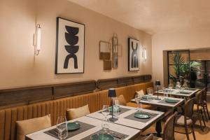 a row of tables in a restaurant with glasses on them at The Residence Aiolou Hotel & Spa in Athens