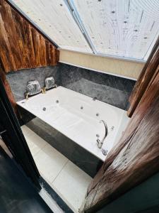 a large bath tub in a room with at Hotel Lares 70 Laureles in Medellín