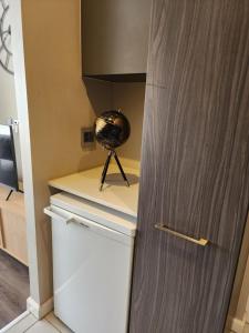 a room with a refrigerator and a globe on a shelf at The Trilogy Penthouse 1603 in Pretoria