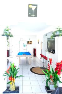 a living room with a ping pong table in it at Maison de 7 chambres avec piscine privee terrasse et wifi a Sainte Anne in Sainte-Anne