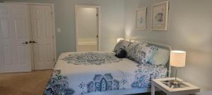 a bedroom with a blue and white bed and a table at Legacy Villa 805 in Gulfport +51 photos