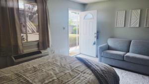 a bedroom with a bed and a couch and a window at Oak Shores 30 in Biloxi +16 photos