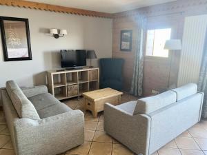 a living room with two chairs and a television at Résidence Les Hauts Bois - maeva Home - Appartement 4 pièces 8 personnes Séle 53 in Aime-La Plagne