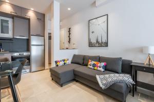 a living room with a couch and a kitchen at Studio-30 by In Vivo Apartments in Athens