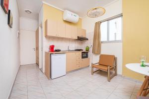 a kitchen with a table and a chair in a room at City Life Marina apartment No. 2 in Ampavris