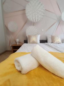 a bedroom with two beds with white pillows and white balls at Pokoje u Daniela in Miedzygorze