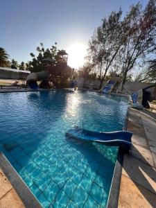 a swimming pool with a slide and a playground at Pousada das Canoas in Acaraú