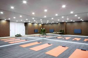 a large room with orange yoga mats on the floor at Van Gogh Apartment, Bedford - Fast Wifi, Gym & FREE Parking in Bedford