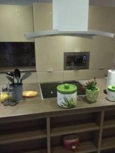 a kitchen counter with three pots on top of it at Anchors Aweigh-Sea View Apart. in Nea Skioni