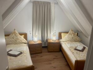 two beds in a room with two lights on them at Wohnung VS 3 in Villingen-Schwenningen