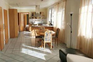 uma cozinha e sala de jantar com mesa e cadeiras em Spacious 100sq m apartment em Tuchenbach
