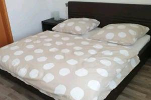 a bed with two pillows with hearts on it at Spacious 100sq m apartment in Tuchenbach