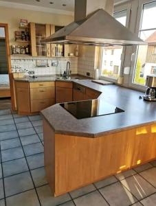 a large kitchen with a large island in the middle at Spacious 100sq m apartment in Tuchenbach