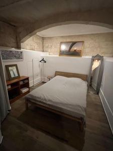 a bedroom with a bed and a picture on the wall at Valletta's Charming Loft Accommodation in Valletta
