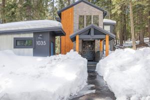 a house covered in snow in front of a fireplace at Sunnyside Retreat - Tahoe City, 4 BR, Pet Friendly, Bonus Room in Tahoe City
