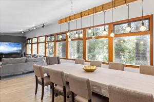 a dining room and living room with a large table and chairs at Sunnyside Retreat - Tahoe City, 4 BR, Pet Friendly, Bonus Room in Tahoe City