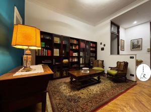 a living room with a table and a lamp on a desk at 3RDomus - Luxury suite con vista Duomo in Turin