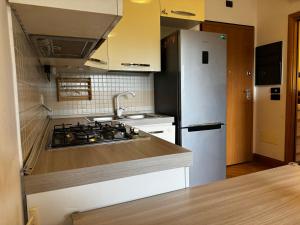 a kitchen with a sink and a refrigerator at DolceVita Eur Torrino Prestige in Rome