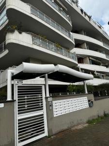 a tall building with a gate and a building at DolceVita Eur Torrino Prestige in Rome