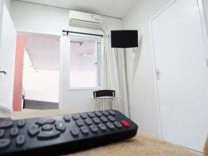 un mando a distancia sentado en una mesa en una habitación en Laf Hotel, en Registro