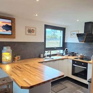 a kitchen with a wooden counter top and a window at Casa Peghera, Chamonix (hypercentre) in Chamonix
