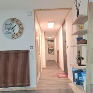 a hallway with a large clock on the wall at Casa Peghera, Chamonix (hypercentre) in Chamonix +14 photos