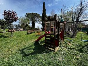a playground with a slide in a park at La Piccola Fattoria nella Campagna Umbra in Badiola
