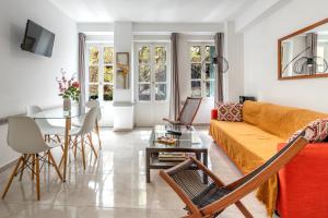 a living room with a couch and a table at Psiri gem from In Vivo Apartments- Spacious 1st floor Apartment with Balcony in Athens' historic center in Athens