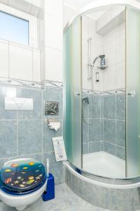 a bathroom with a toilet with fish painted on it at Apartments Mrvelj in Gdinj +34 photos