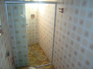 a shower with a glass door in a bathroom at Oberherr in Gramado