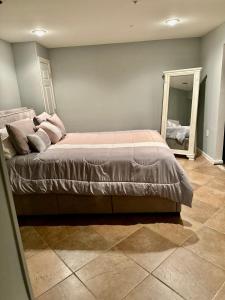 a bedroom with a large bed and a mirror at The Oasis@Woodyard in Upper Marlboro