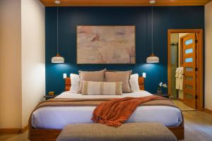 a bedroom with a large bed with blue walls at Aspire in Glacier