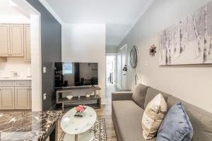 a living room with a couch and a table at James St Apartment Unit - Sleeps 6 in Hamilton