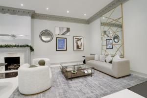 a living room with white furniture and a fireplace at Spacious & Comfortable Condo at Crystal City in Arlington