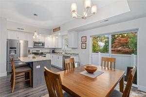 a kitchen with a wooden table and a dining room at New Town House - Heart of Wenatchee in Wenatchee