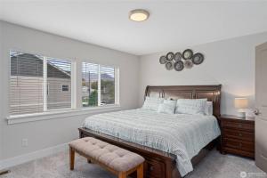a bedroom with a bed and two windows at New Town House - Heart of Wenatchee in Wenatchee
