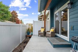 a patio with two chairs and a fence at New Town House - Heart of Wenatchee in Wenatchee