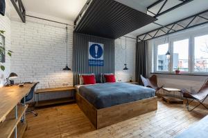 a bedroom with a bed and a brick wall at Solaris in Ostrava
