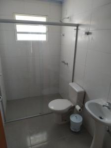 a bathroom with a shower and a toilet and a sink at My House Hospedagem in Santo Ângelo
