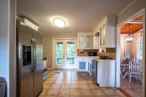 a kitchen with white cabinets and a refrigerator at Oxford Hillside Hideaway in Oxford +31 photos