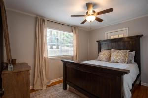 a bedroom with a bed with a ceiling fan and a window at Oxford Hillside Hideaway in Oxford