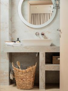 a bathroom with a sink and a mirror at Kayy Apartments 3 in Matala in Matala +18 photos